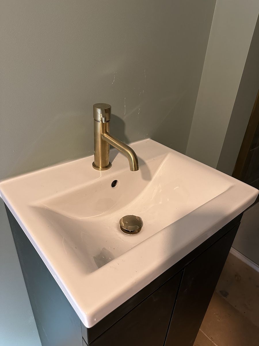 Brushed gold mono tap on a new vanity basin in a finished bathroom renovation